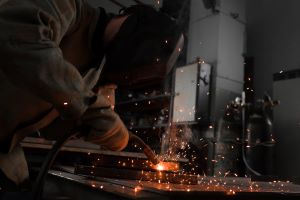 manufacture-worker-welding-metal-with-sparks-at-fa-2022-12-16-18-42-10-utc